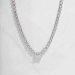 Sterling silver tennis necklace for her with tiny diamonds and baguette pendant, on white marble background