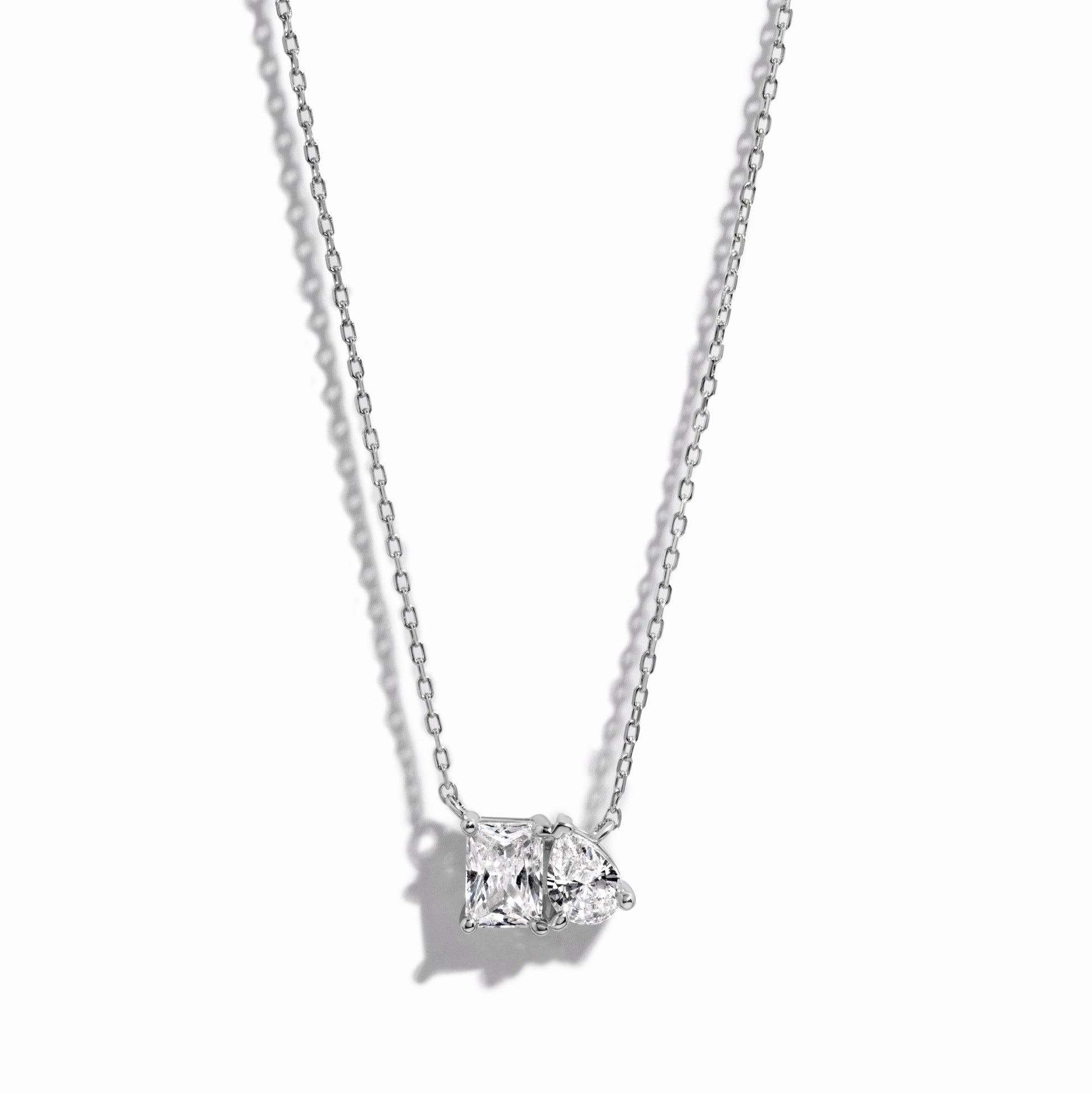 closeup image of sterling silver emerald cut and pear cut necklace