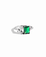 closeup image of emerald green toi et moi ring in sterling silver