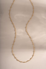 Close-up of a gold beaded necklace from Sami Jewels showing small round beads on a delicate chain.