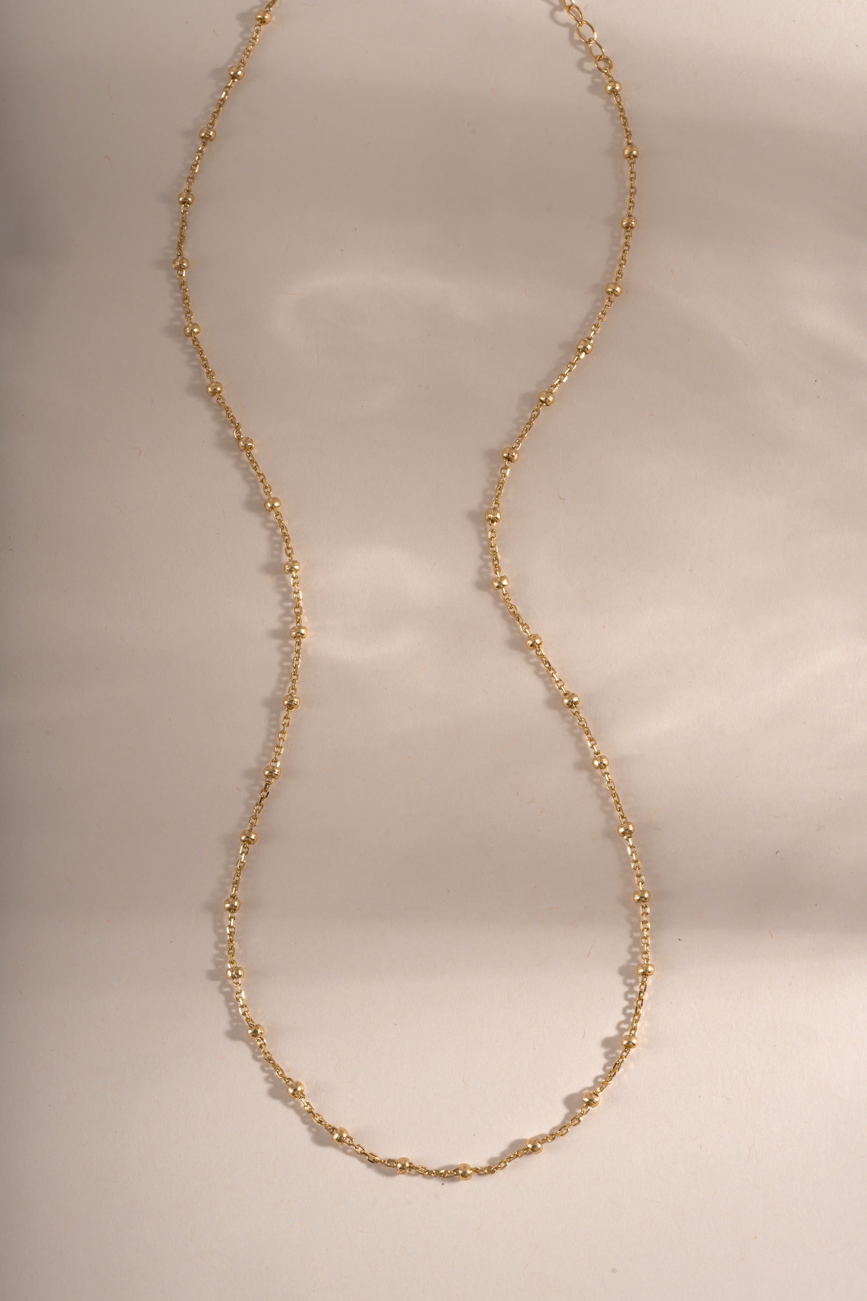 Close-up of a gold beaded necklace from Sami Jewels showing small round beads on a delicate chain.
