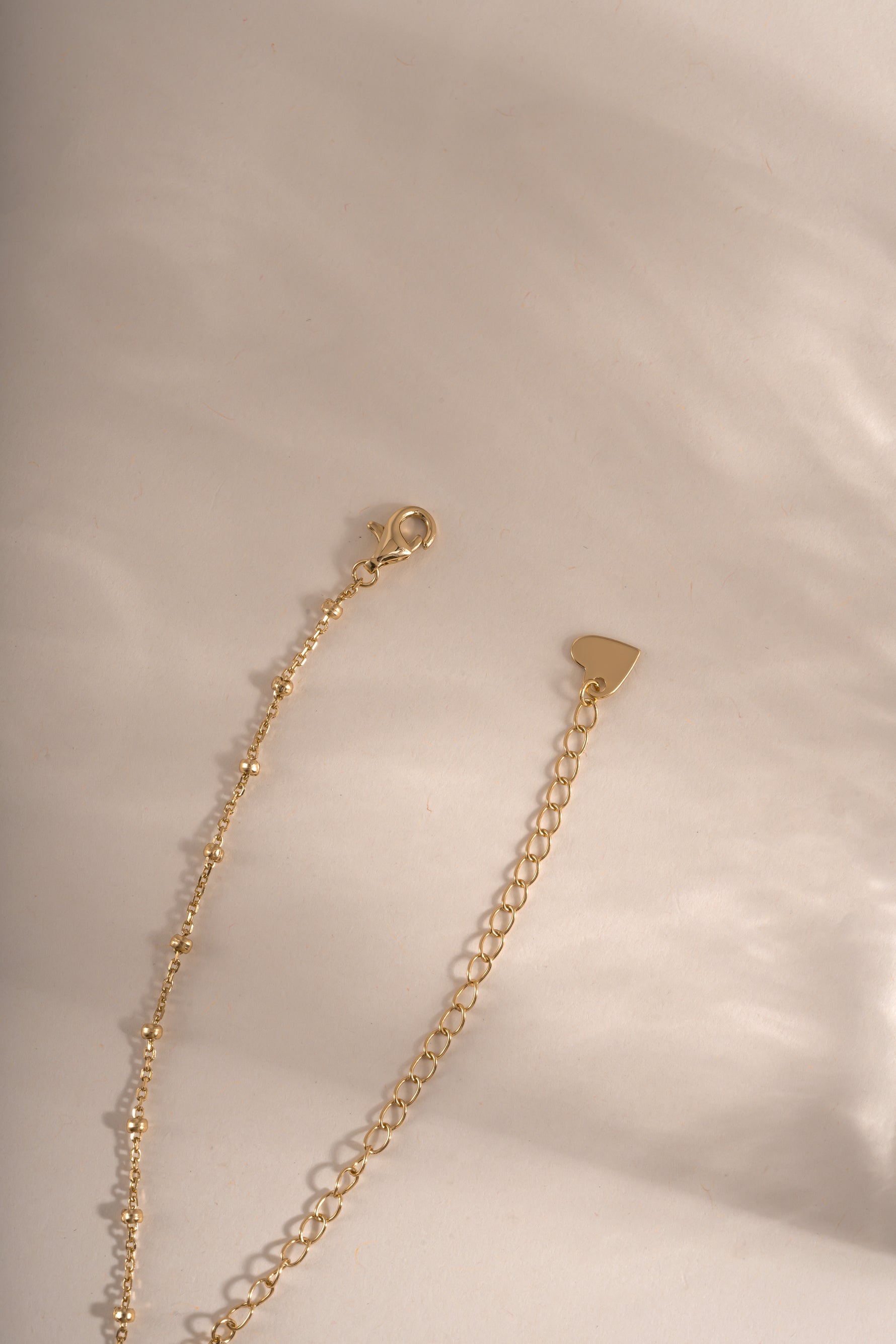 Gold beaded necklace from Sami Jewels featuring a lobster clasp closure and simple, elegant design.