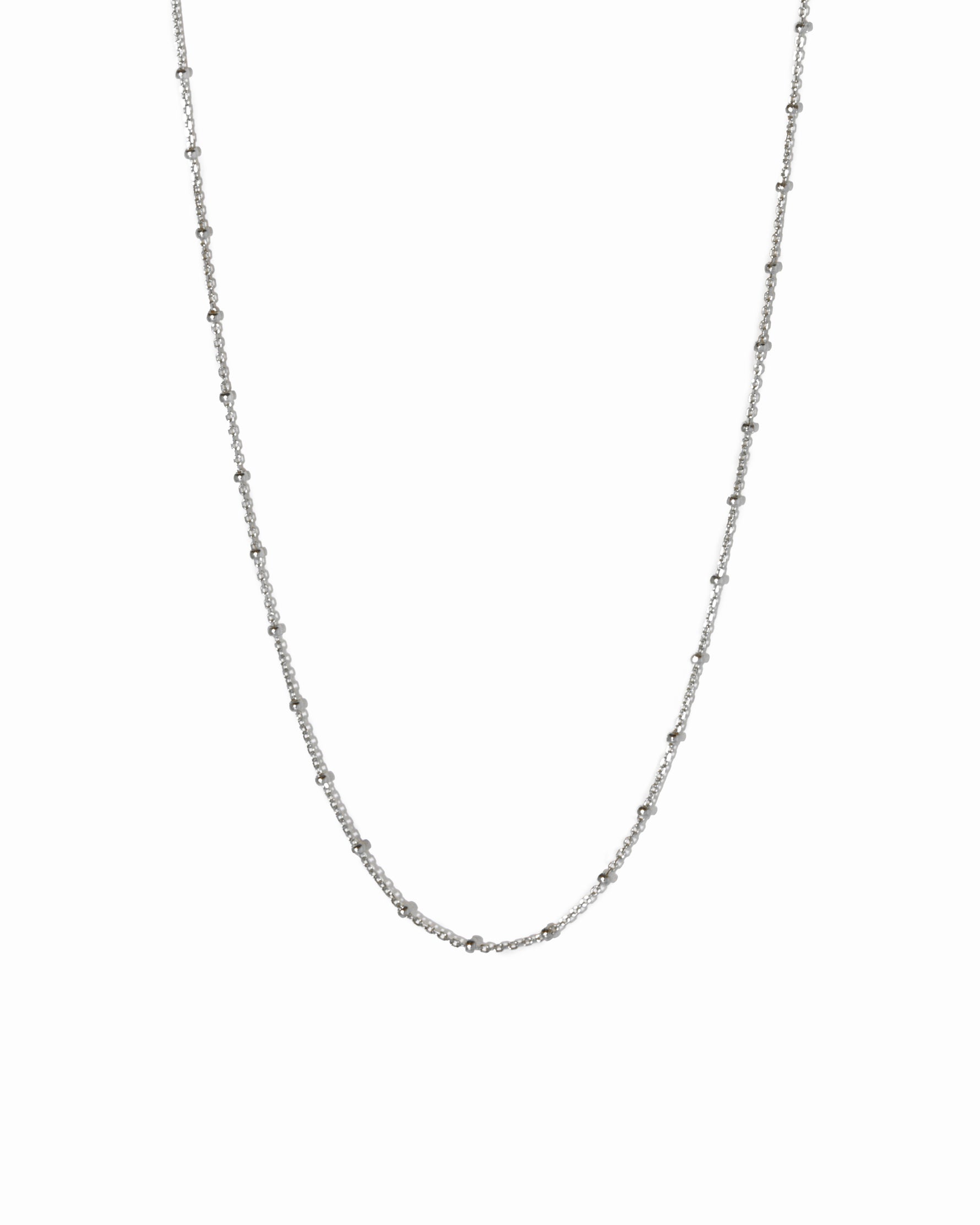 Sterling silver beaded necklace from Sami Jewels, featuring a simple design with small white beads against a white background.