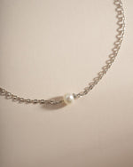 Close-up of Sami Jewels' simple freshwater pearl bracelet made with sterling silver, featuring smooth white pearls on a delicate chain.