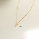 Small tiny 9mm plain cross necklace on white background