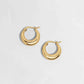 Gold statement hoop earrings on white background with hinge closure