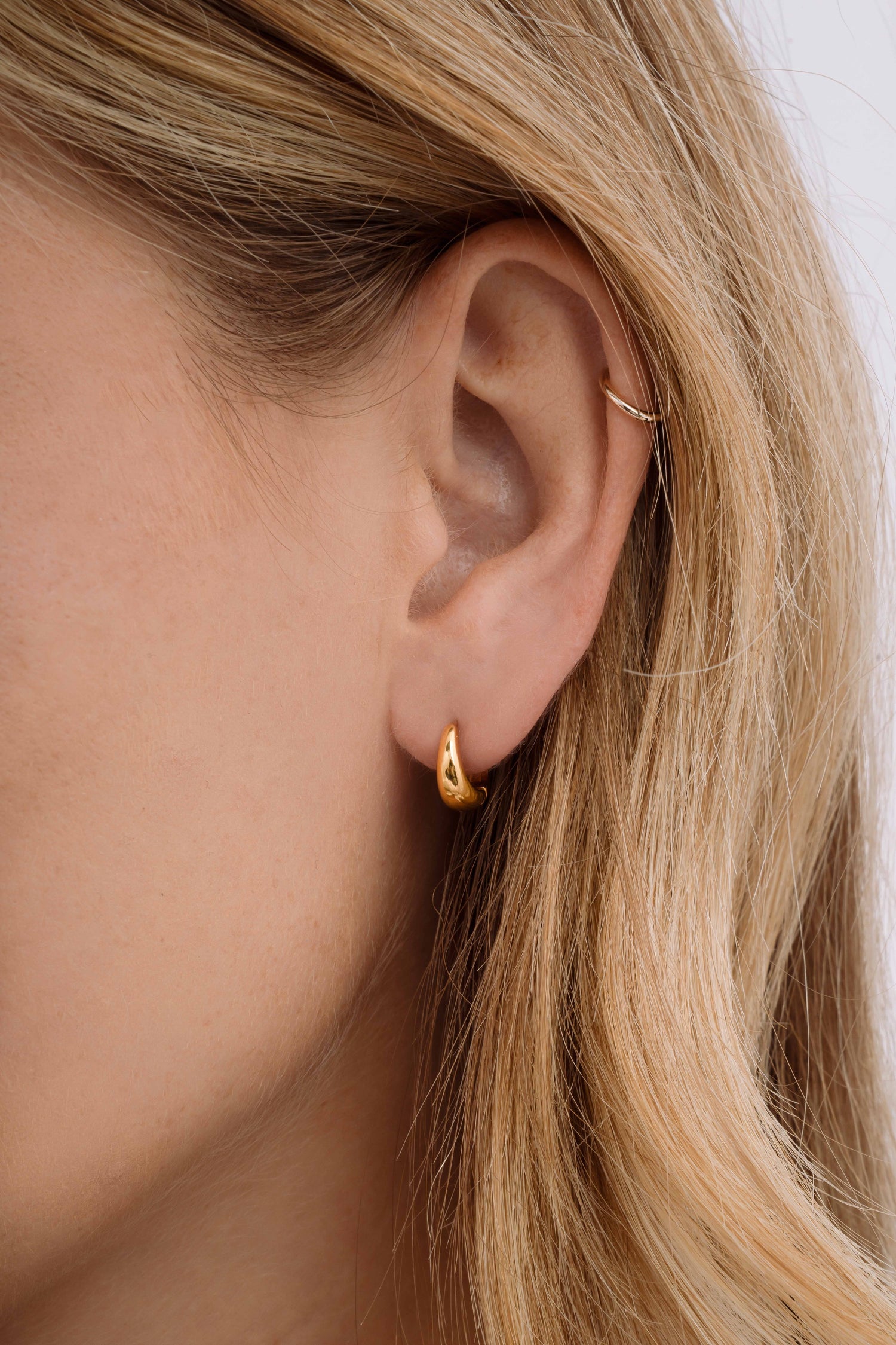 Gold stainless steel SS Small Hoops earrings by Sami Jewels, showcasing sleek, waterproof hoop earrings on a model.