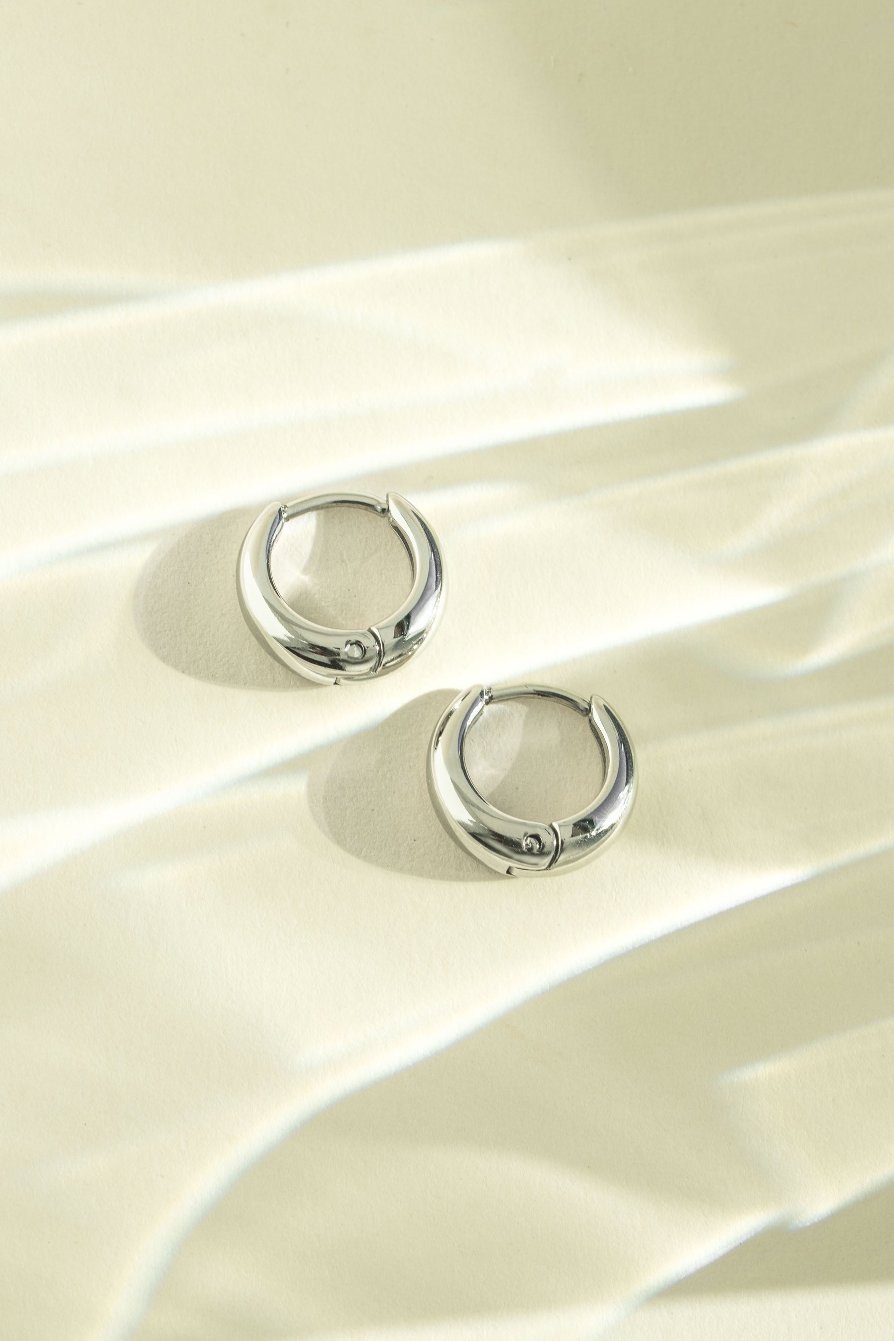 Silver stainless steel SS small hoop earrings by Sami Jewels, showcasing a sleek, waterproof design with a polished finish.