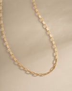 Close-up of Sami Jewels small gold paperclip necklace, showcasing its sleek, minimalist design and shiny finish.