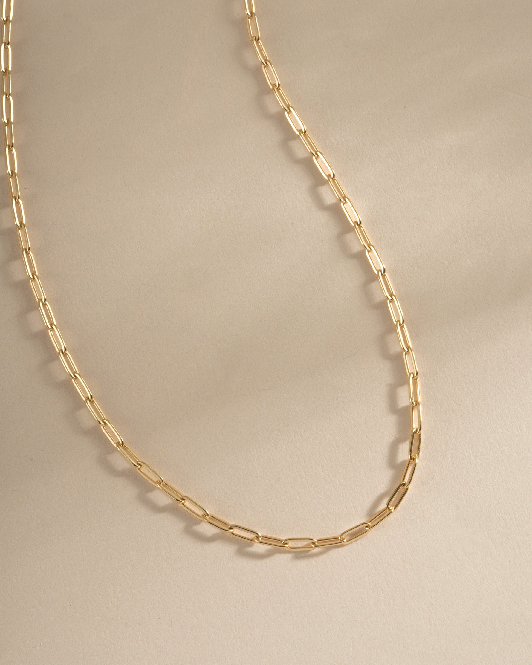 Close-up of Sami Jewels small gold paperclip necklace, showcasing its sleek, minimalist design and shiny finish.