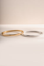 Gold and silver solid bangle bracelet from Sami Jewels with a sleek, polished design, shown from the front view.