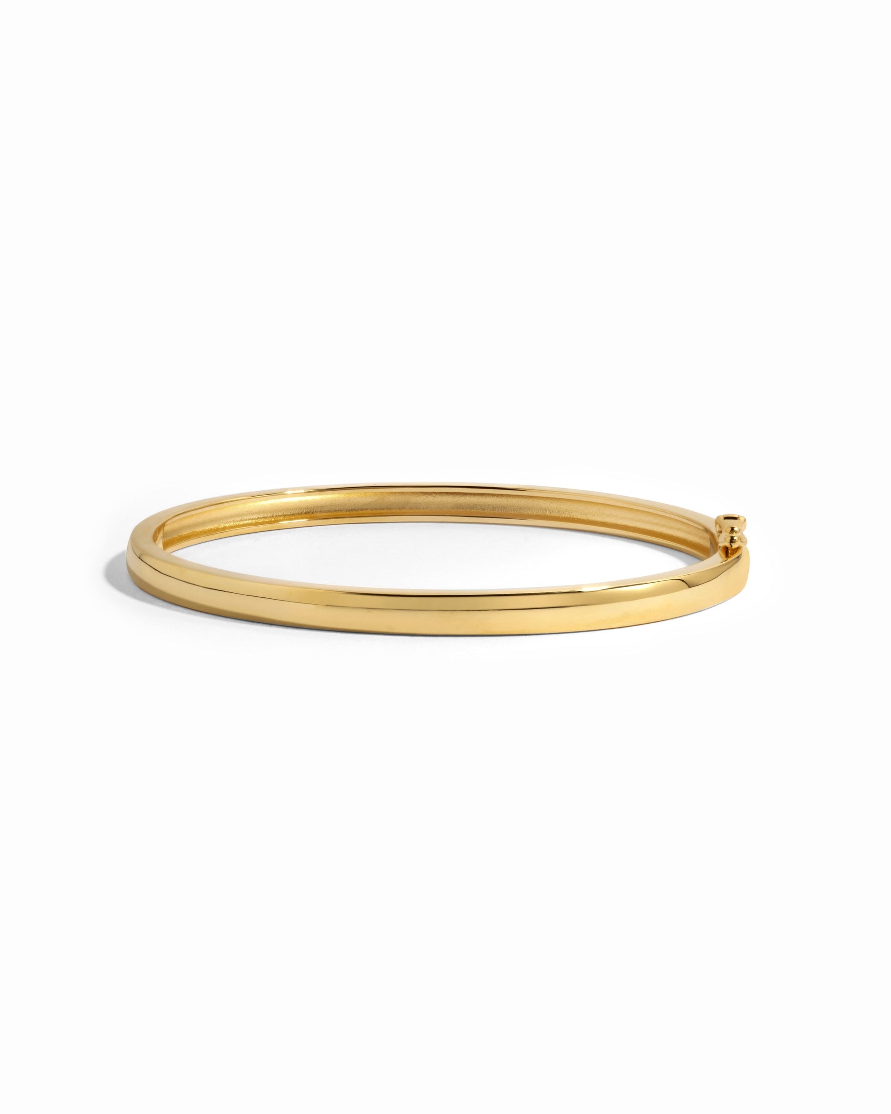 Gold solid bangle bracelet from Sami Jewels with a smooth, polished finish on a white background.