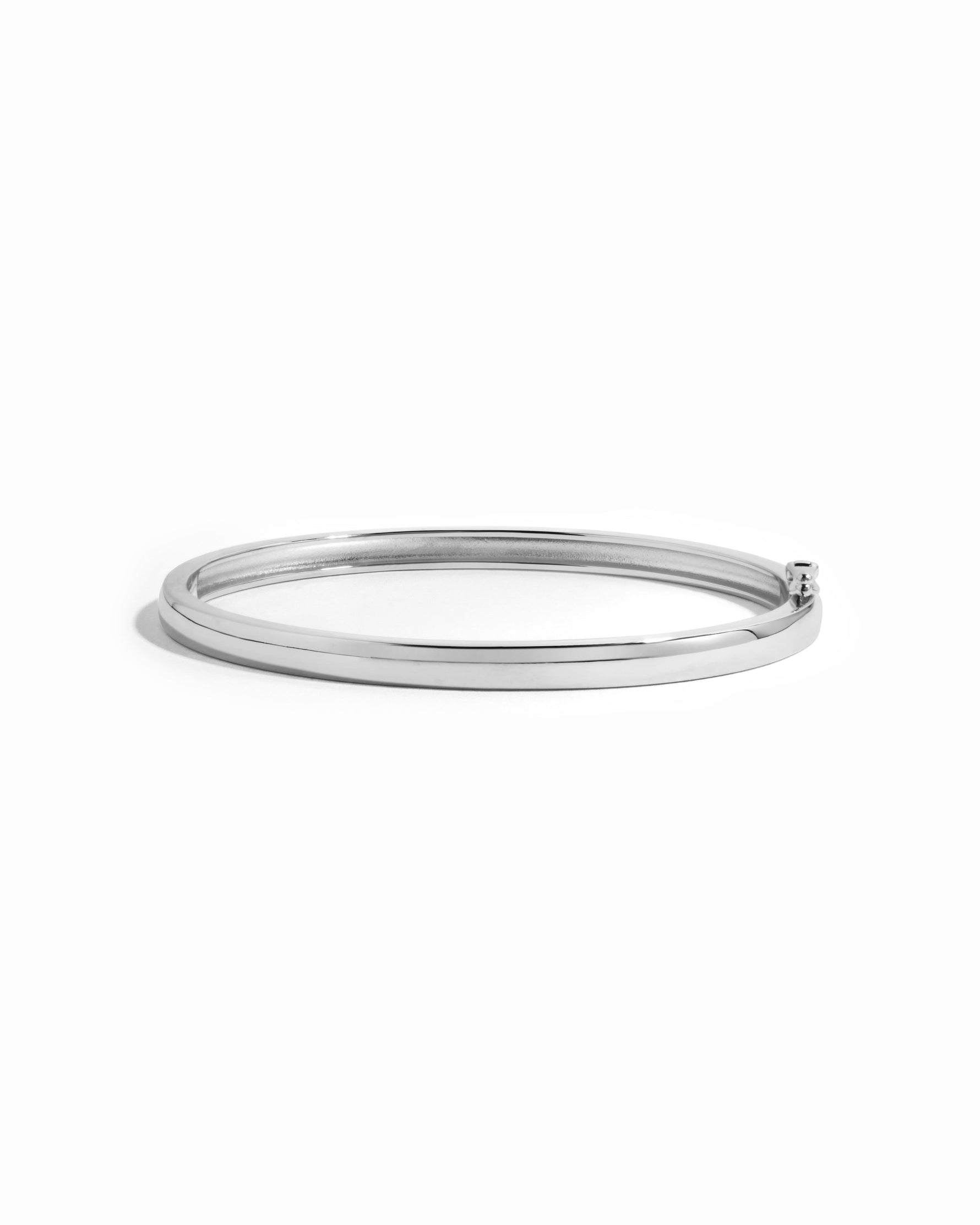 Silver solid bangle bracelet by Sami Jewels displayed on a white background, showcasing its sleek and polished design.
