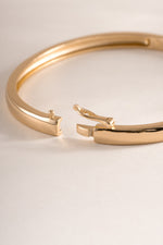 Gold solid bangle bracelet by Sami Jewels featuring a sleek closure style and smooth, polished finish.