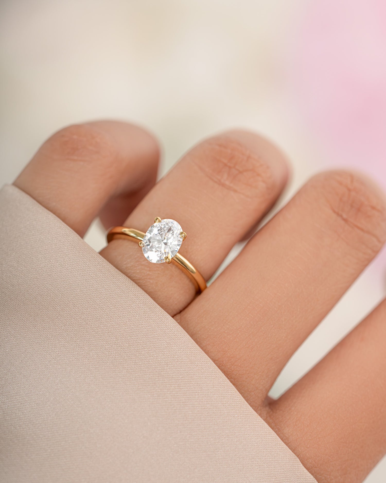 Gold Solitaire Oval Ring by Sami Jewels featuring a sleek oval-shaped gemstone set in a classic ring design.
