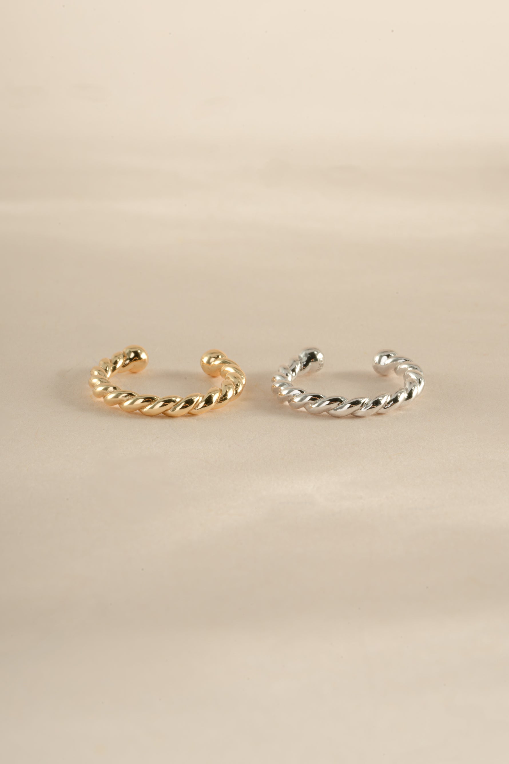 Gold and sterling silver spiral ear cuff earrings by Sami Jewels, showcasing a stylish and modern jewelry design.