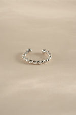 Sterling silver spiral ear cuff earrings by Sami Jewels, showcasing a sleek, modern design for pierced or cartilage ears.