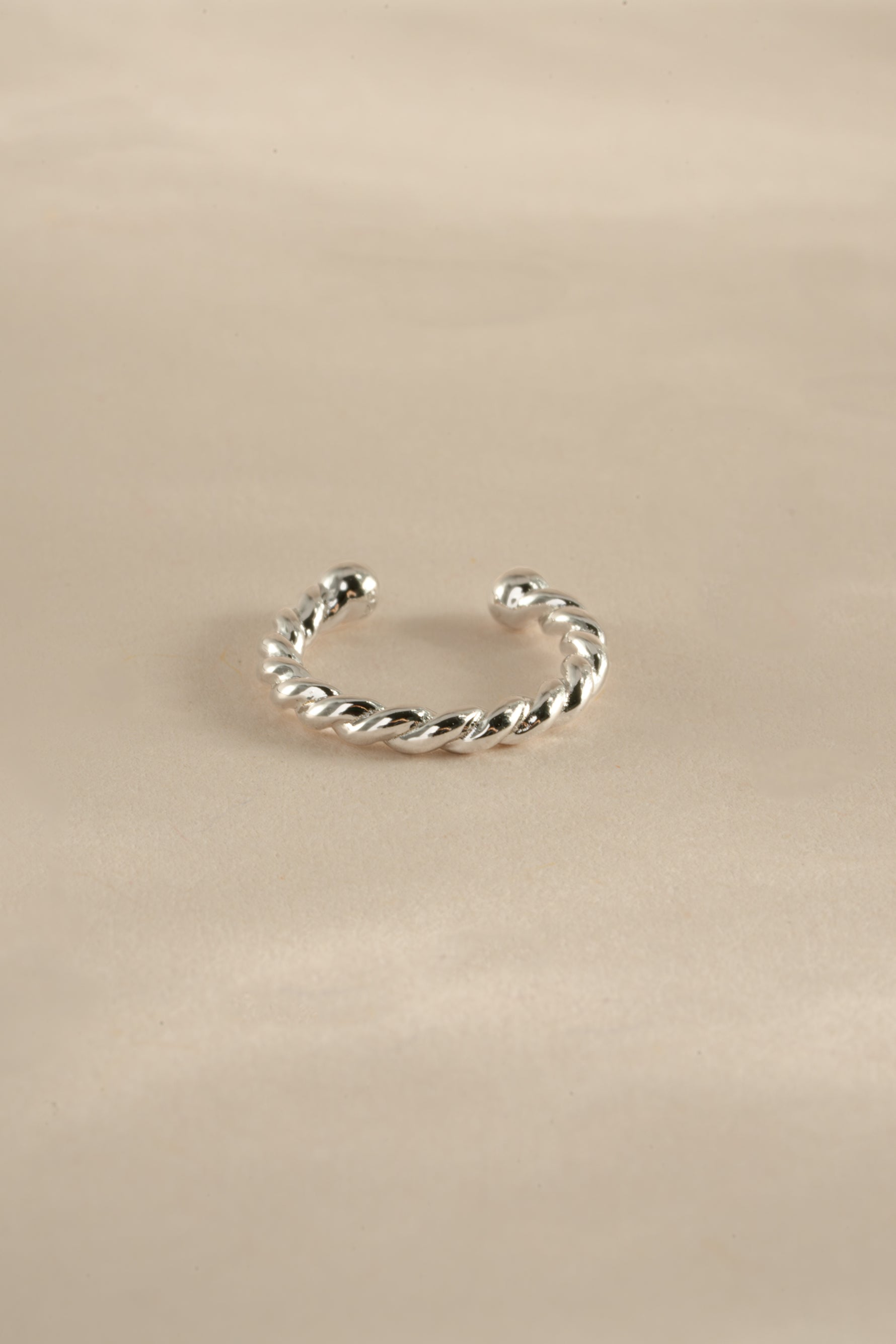 Sterling silver spiral ear cuff earrings by Sami Jewels, showcasing a sleek, modern design for pierced or cartilage ears.