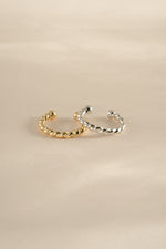 Gold and sterling silver spiral ear cuff earrings by Sami Jewels, featuring a sleek, modern design for stylish ear adornment.
