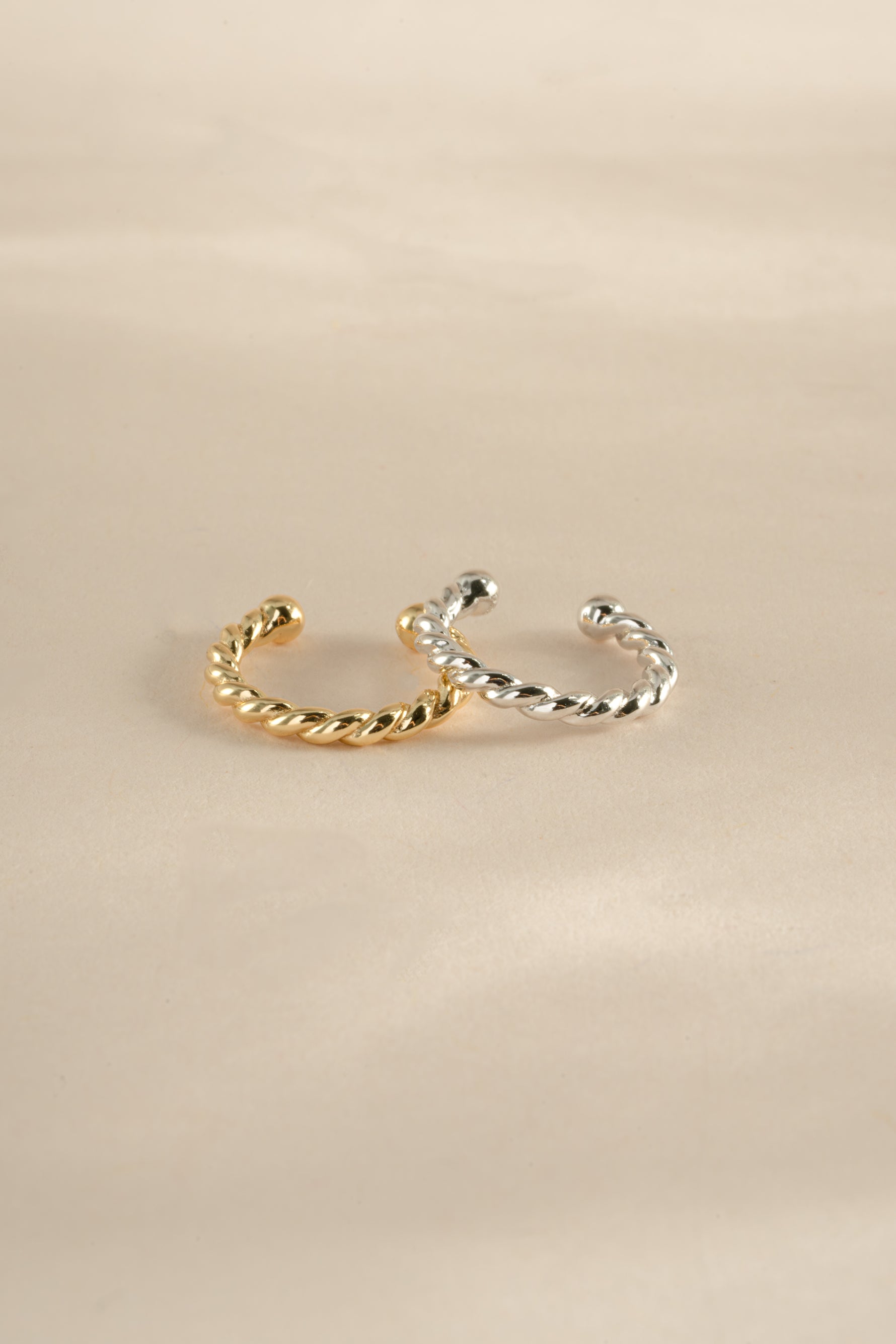 Gold and sterling silver spiral ear cuff earrings by Sami Jewels, featuring a sleek, modern design for stylish ear adornment.