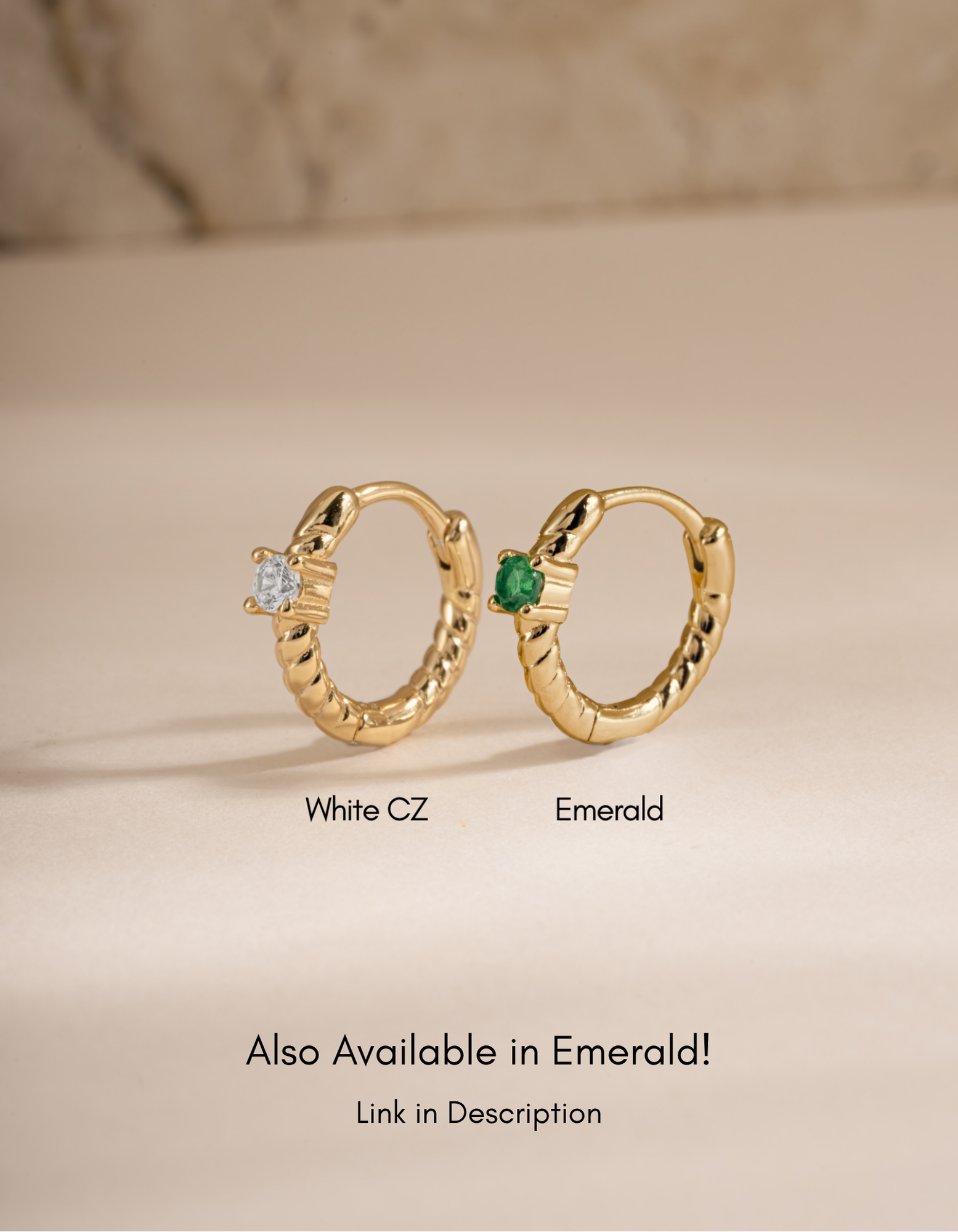 Gold diamond spiral huggie earrings by Sami Jewels featuring emerald and white cubic zirconia accents.
