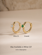 Gold Emerald Spiral Huggie Hoop Earrings by Sami Jewels featuring white CZ accents and a sleek, spiral design.