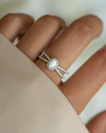 Sterling silver split shank opal ring with vibrant multi-colored opal gemstone and intricate band design.