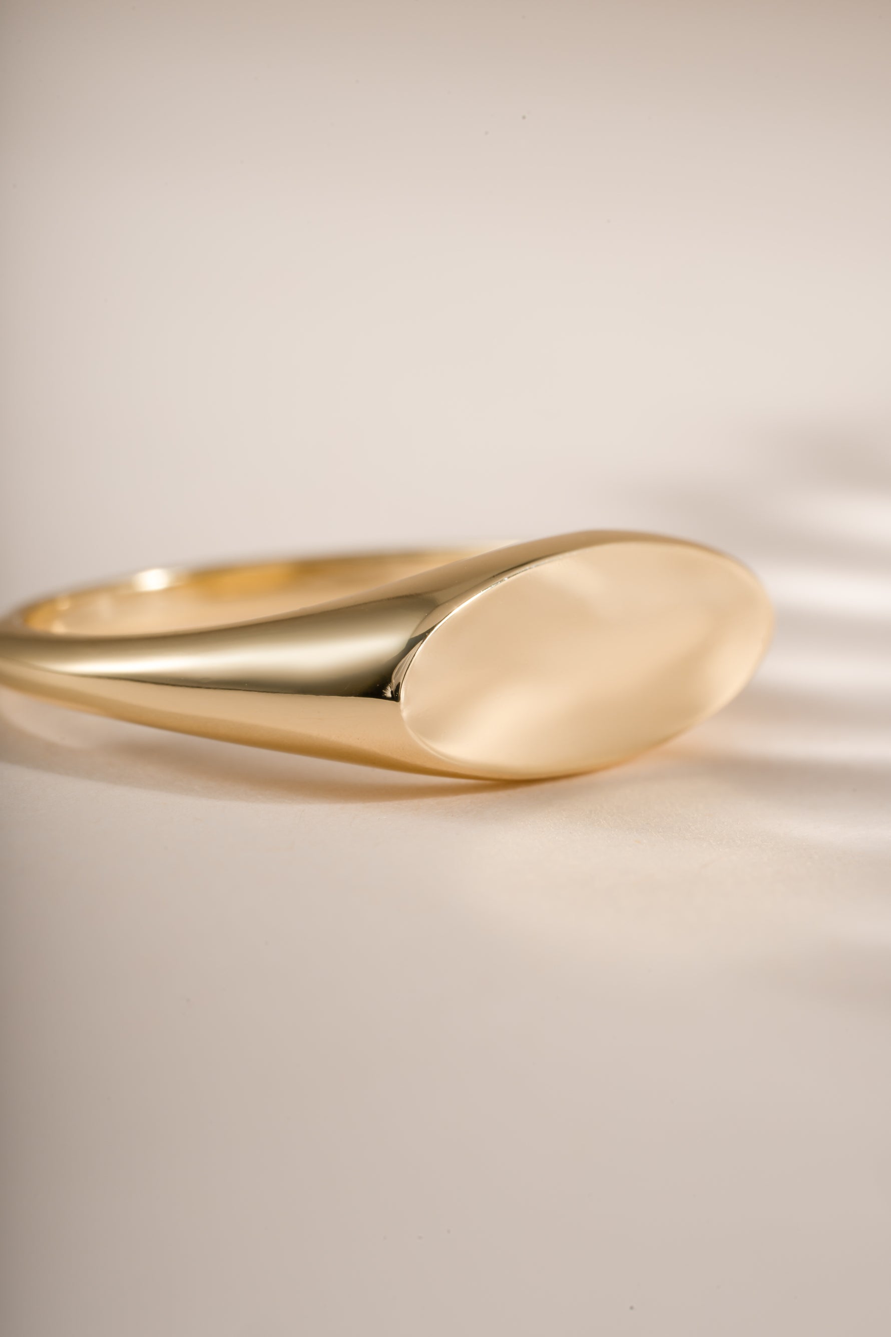Close-up of a gold Square Signet Ring by Sami Jewels, showcasing its sleek, polished square face and elegant design.