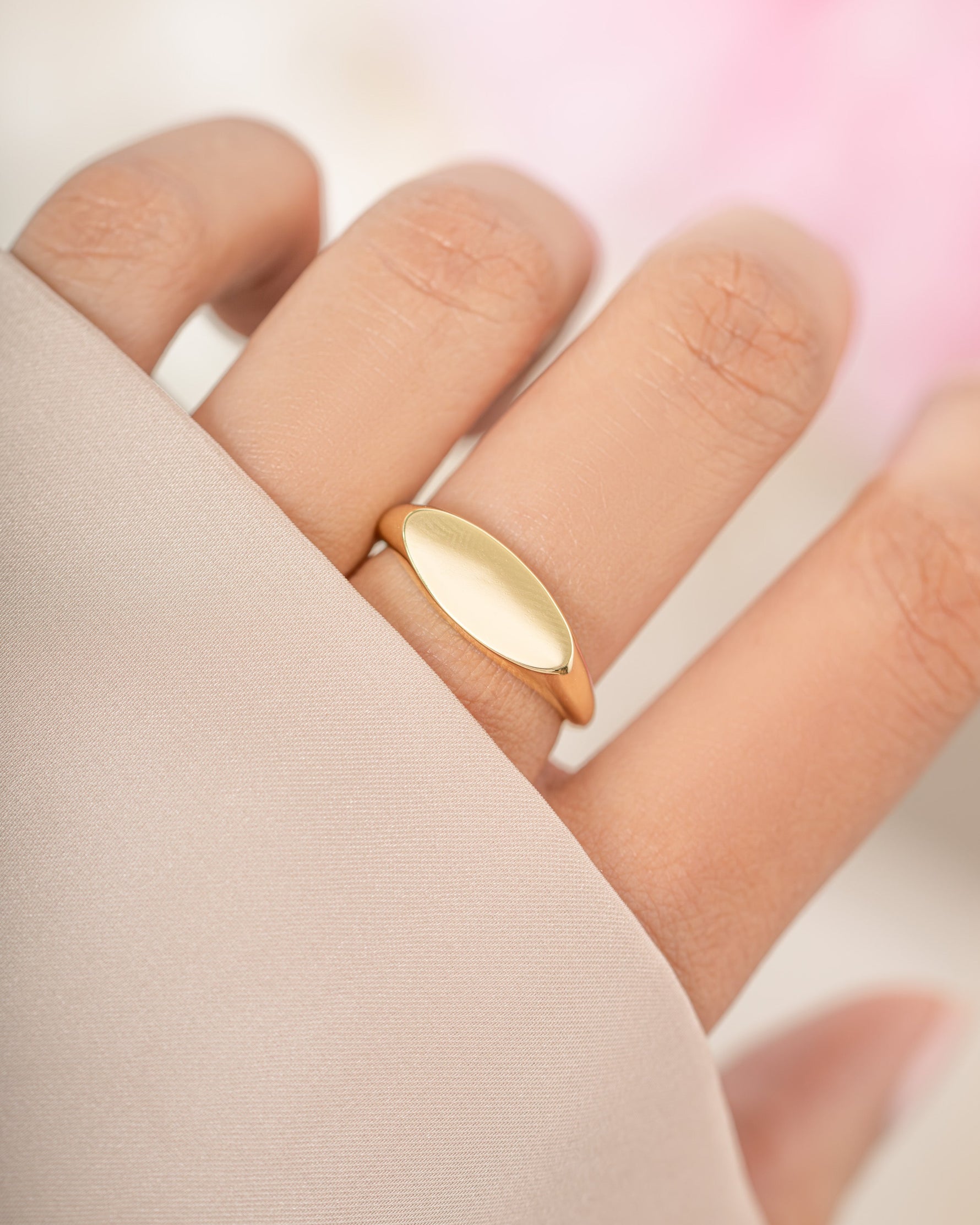 Gold square signet ring from Sami Jewels, showcasing a sleek, modern design on a model's finger.