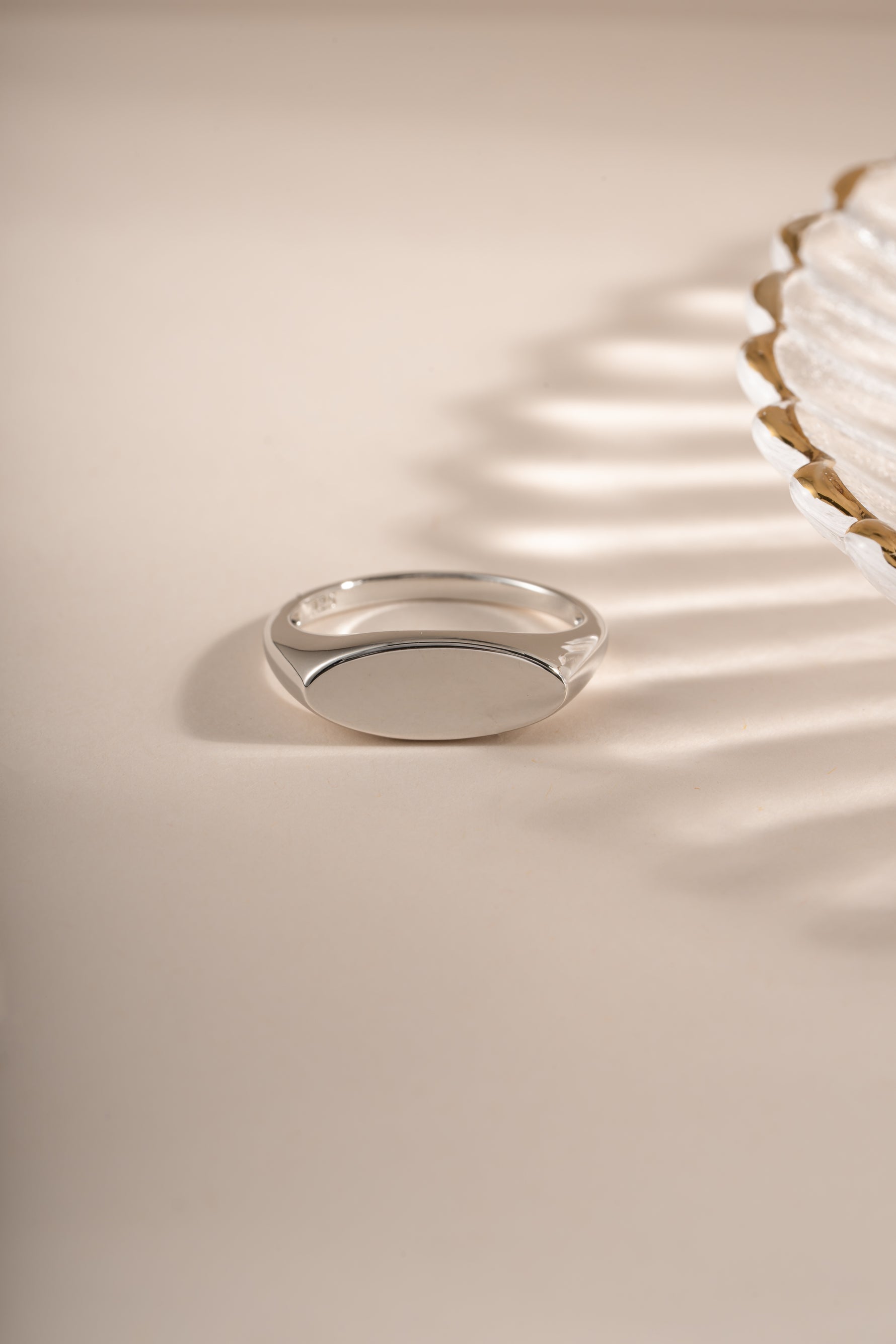Close-up of Sami Jewels sterling silver square signet ring showing its polished, geometric design on a plain background.