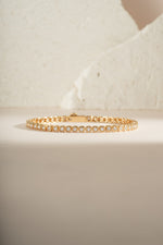 Close-up of Sami Jewels Chloe Tennis Bracelet in gold, showcasing its elegant design and sparkling tennis bracelet style.