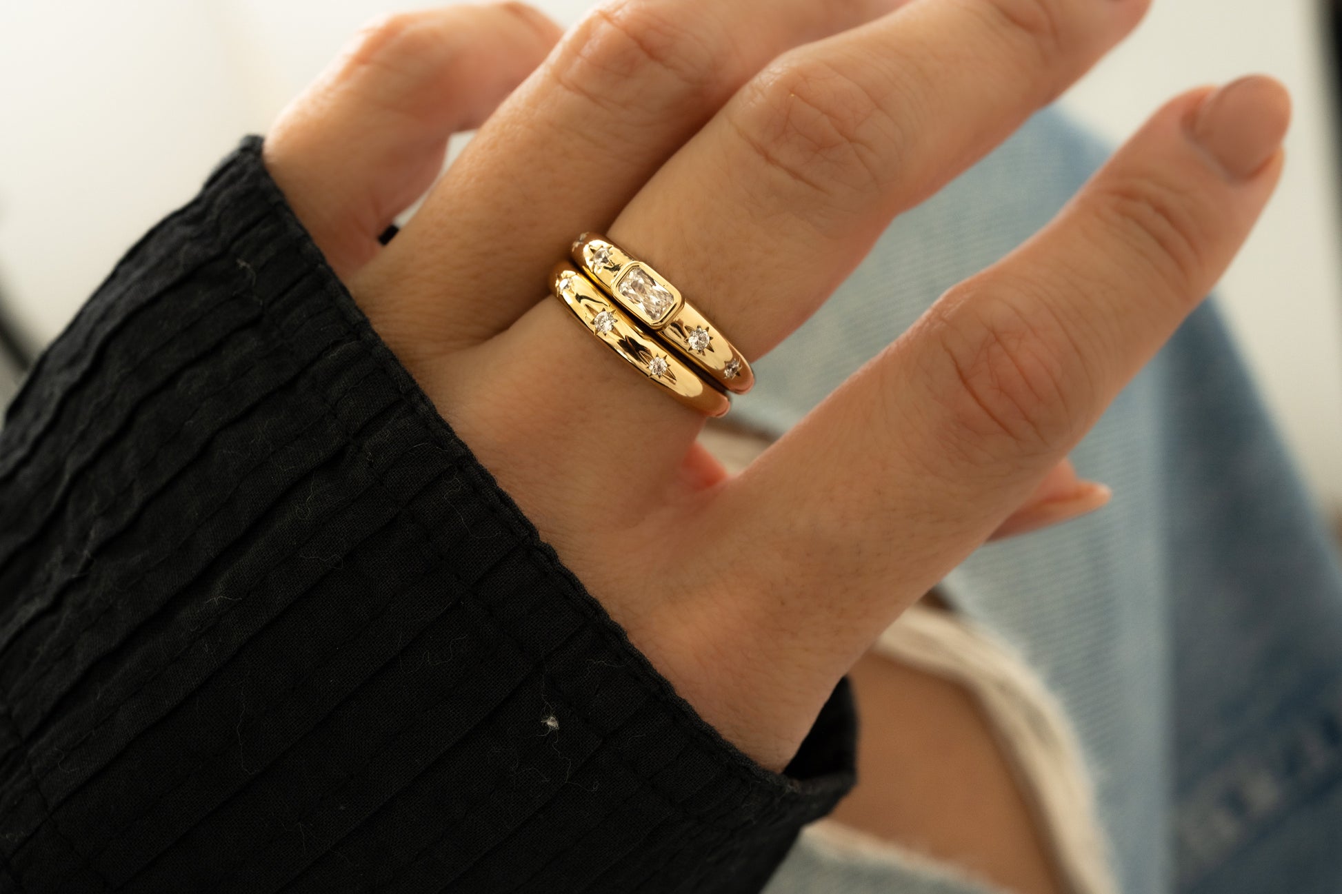 Closeup of Stacked Diamond Starburst Rings on model