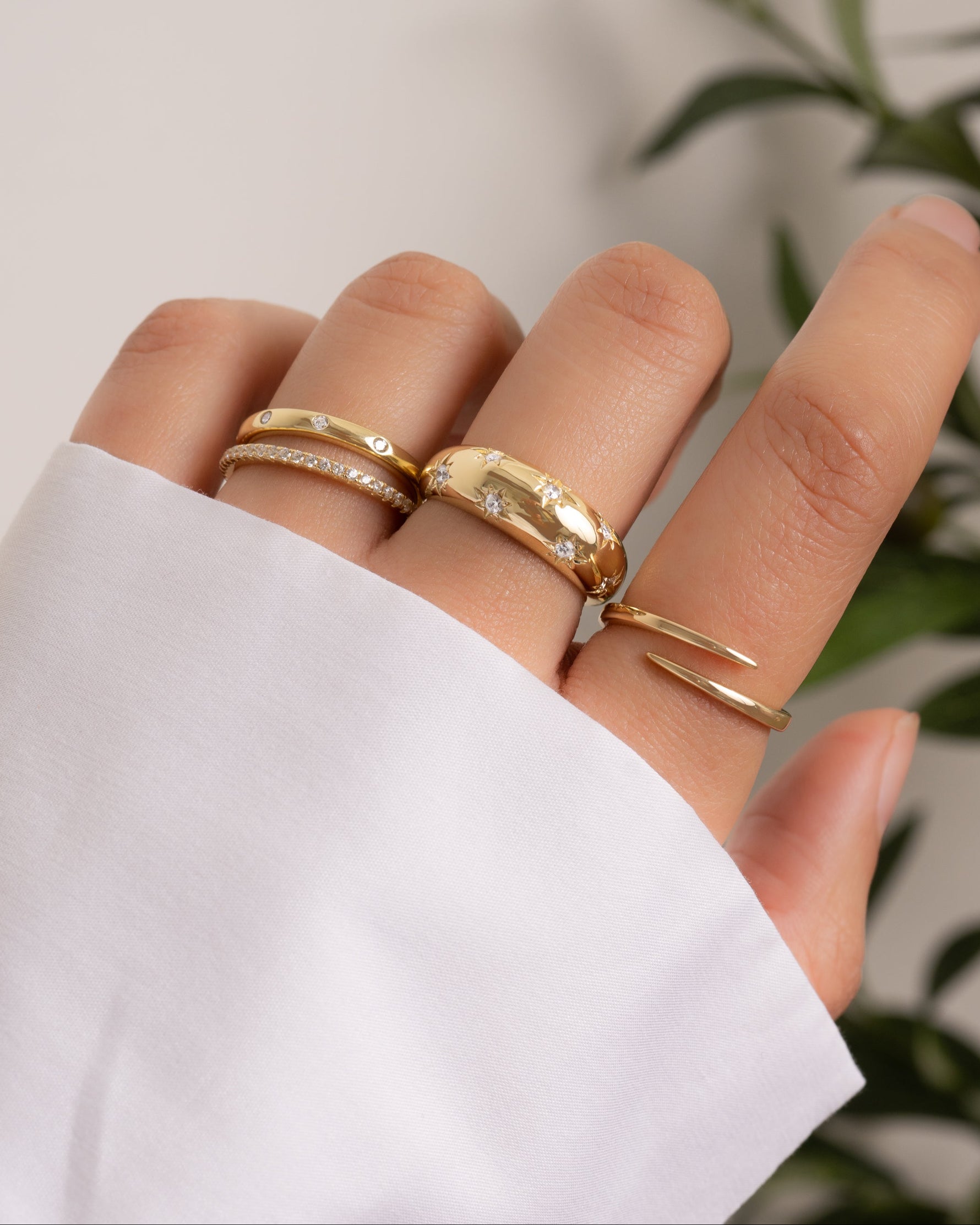 Gold Star Dome Ring by Sami Jewels worn on a model's finger, showcasing its unique dome design and elegant style.