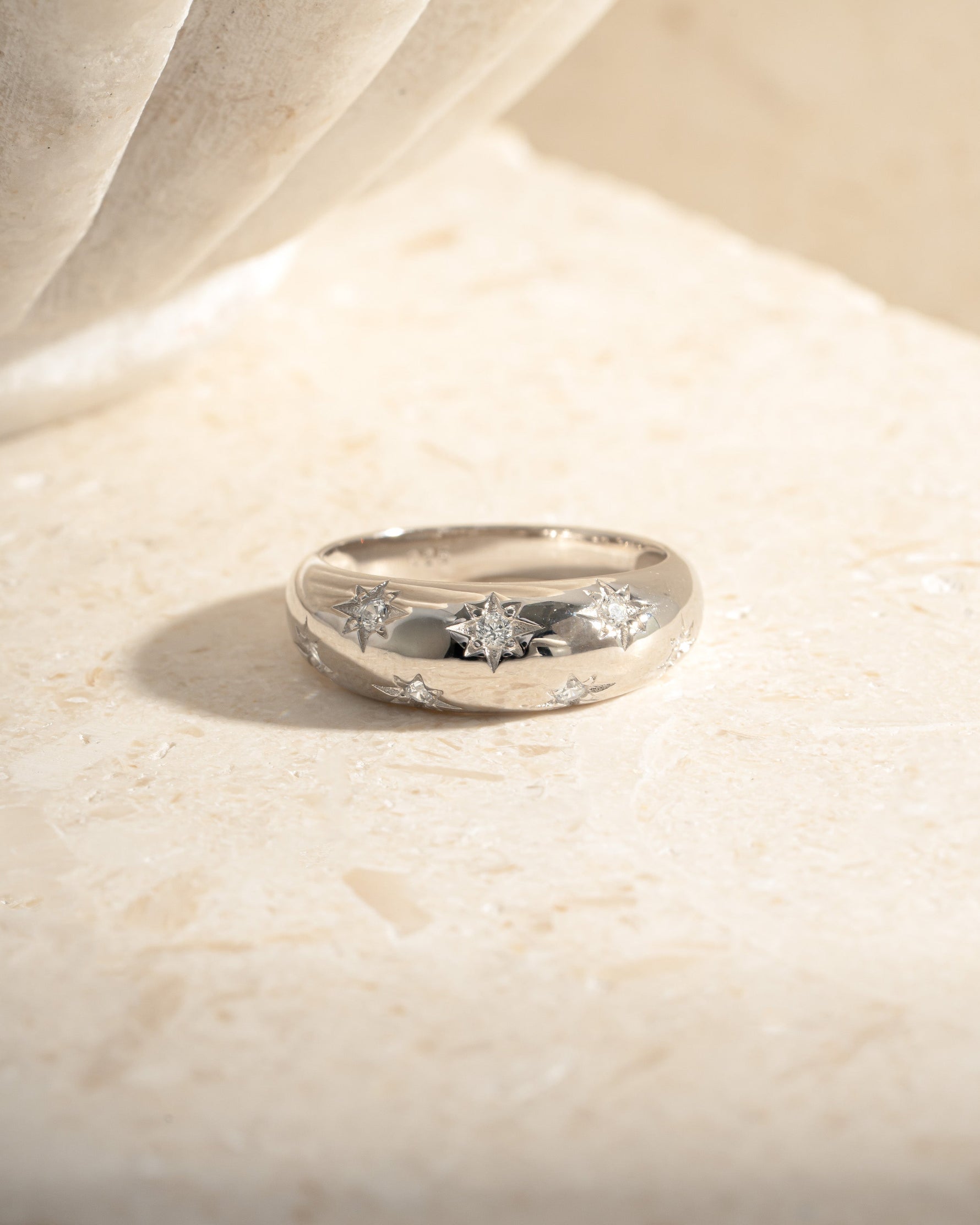 Sterling silver Star Dome Ring by Sami Jewels displayed in a flat lay arrangement with a soft background.
