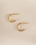 Gold hoop earrings by Sami Jewels featuring star-shaped studs, shown in a side profile view.