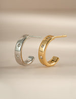 Sterling silver and gold star-studded hoop earrings by Sami Jewels, showcasing a celestial design.