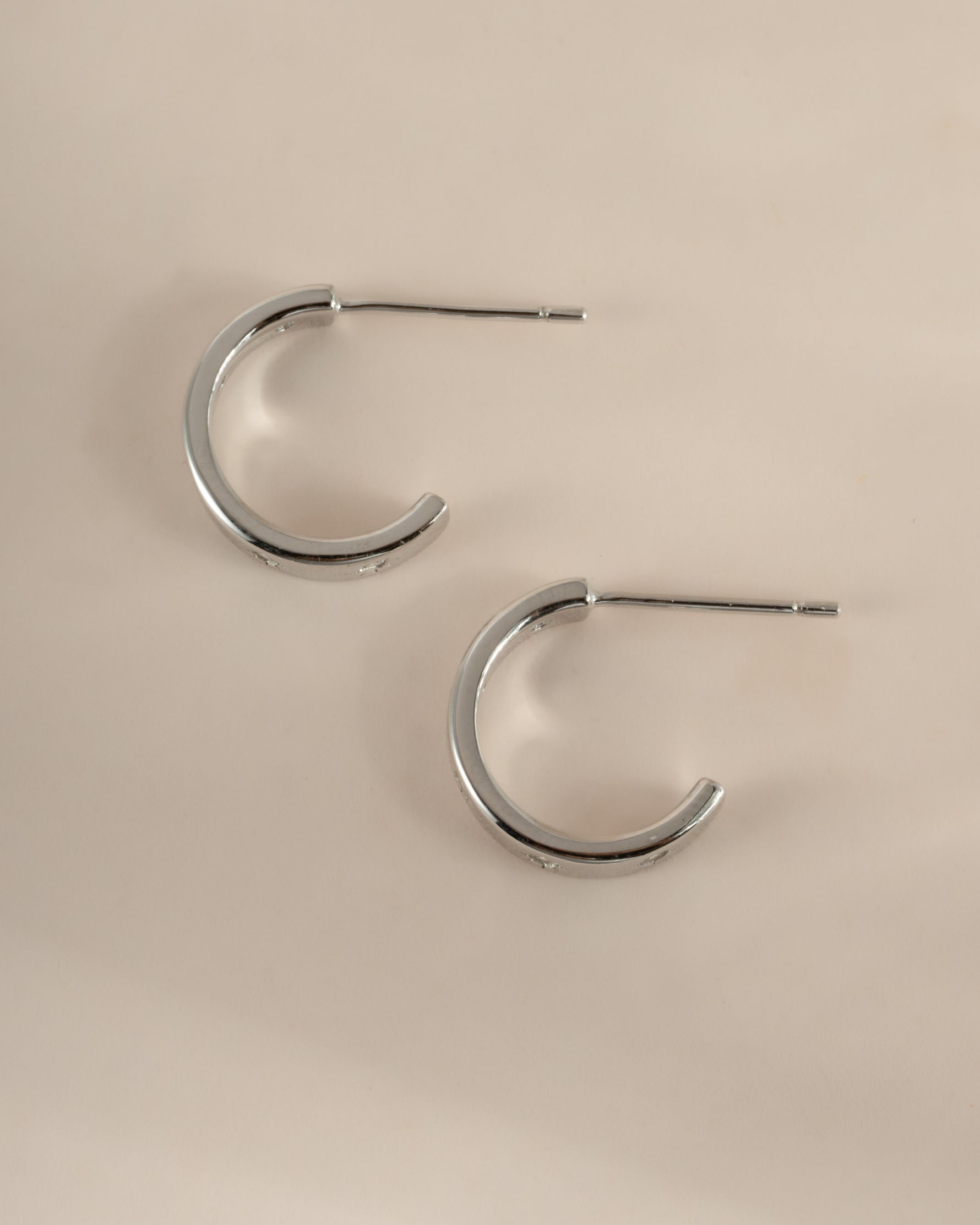 Sterling silver star-studded hoop earrings by Sami Jewels, showcasing a side profile view with celestial star accents.