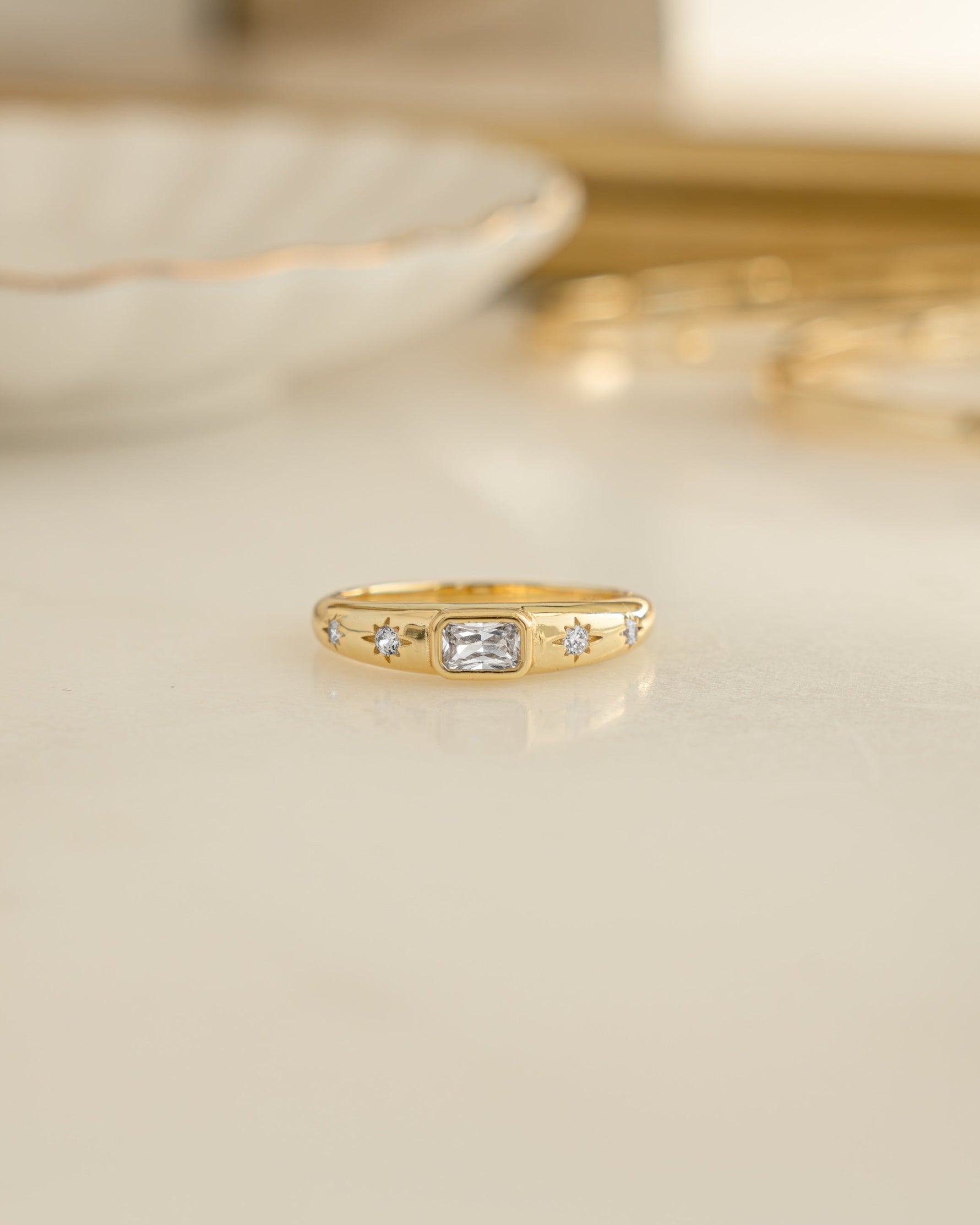 Gold Baguette Starburst Ring by Sami Jewels featuring a starburst design with baguette-cut gemstones, front view.