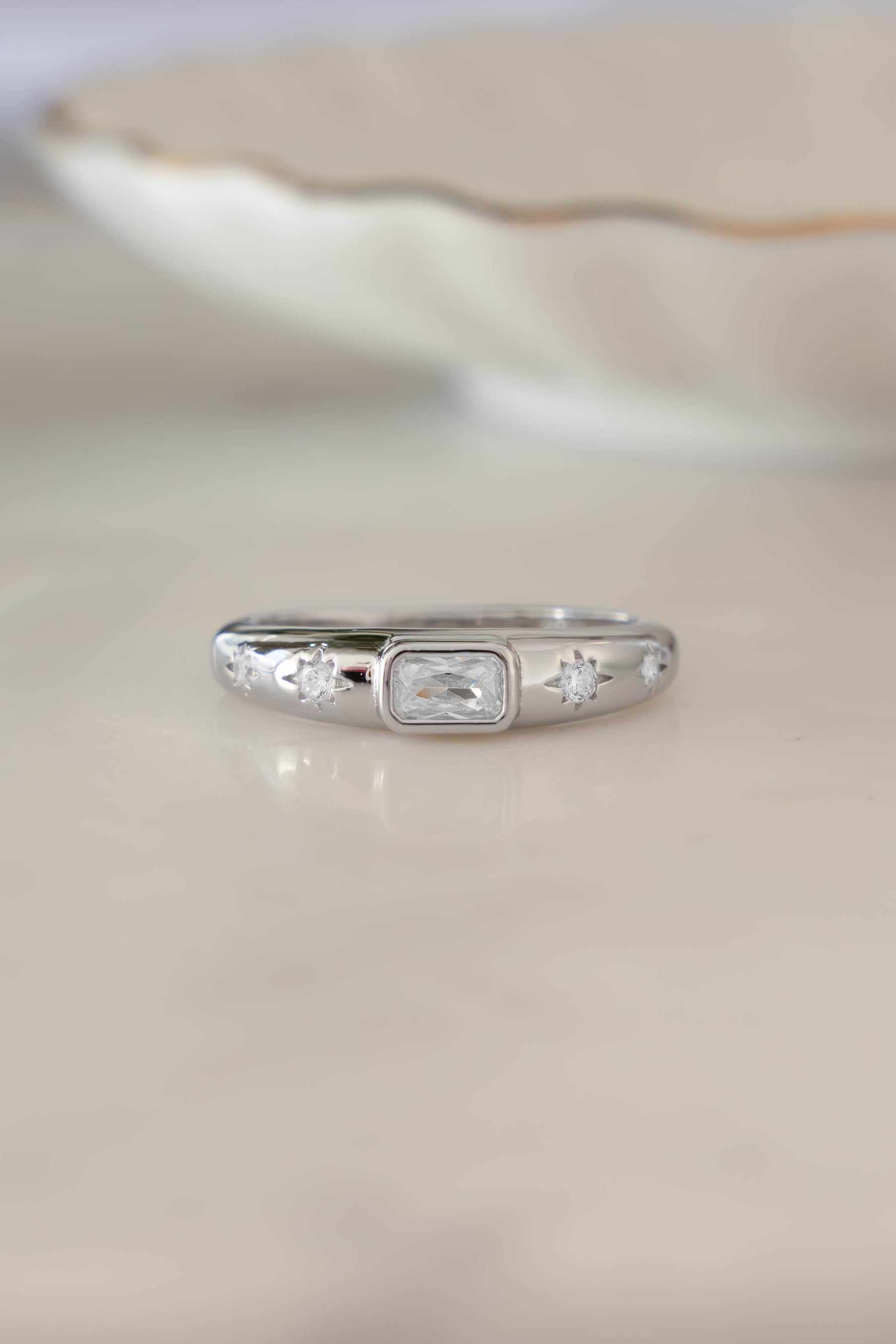 Sterling silver Baguette Starburst Ring by Sami Jewels featuring a starburst design and baguette-cut accents, front view.