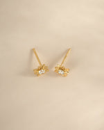Gold starburst earrings from Sami Jewels, top view showing intricate design and shiny finish.