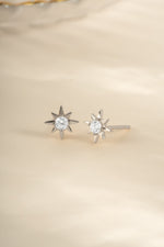 Sterling silver Starburst Earrings by Sami Jewels, angled view showing intricate design and shiny finish.