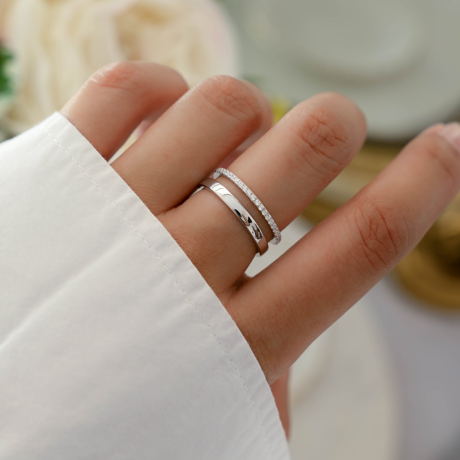 Model wearing dual band design ring in silver with tiny cz diamonds.