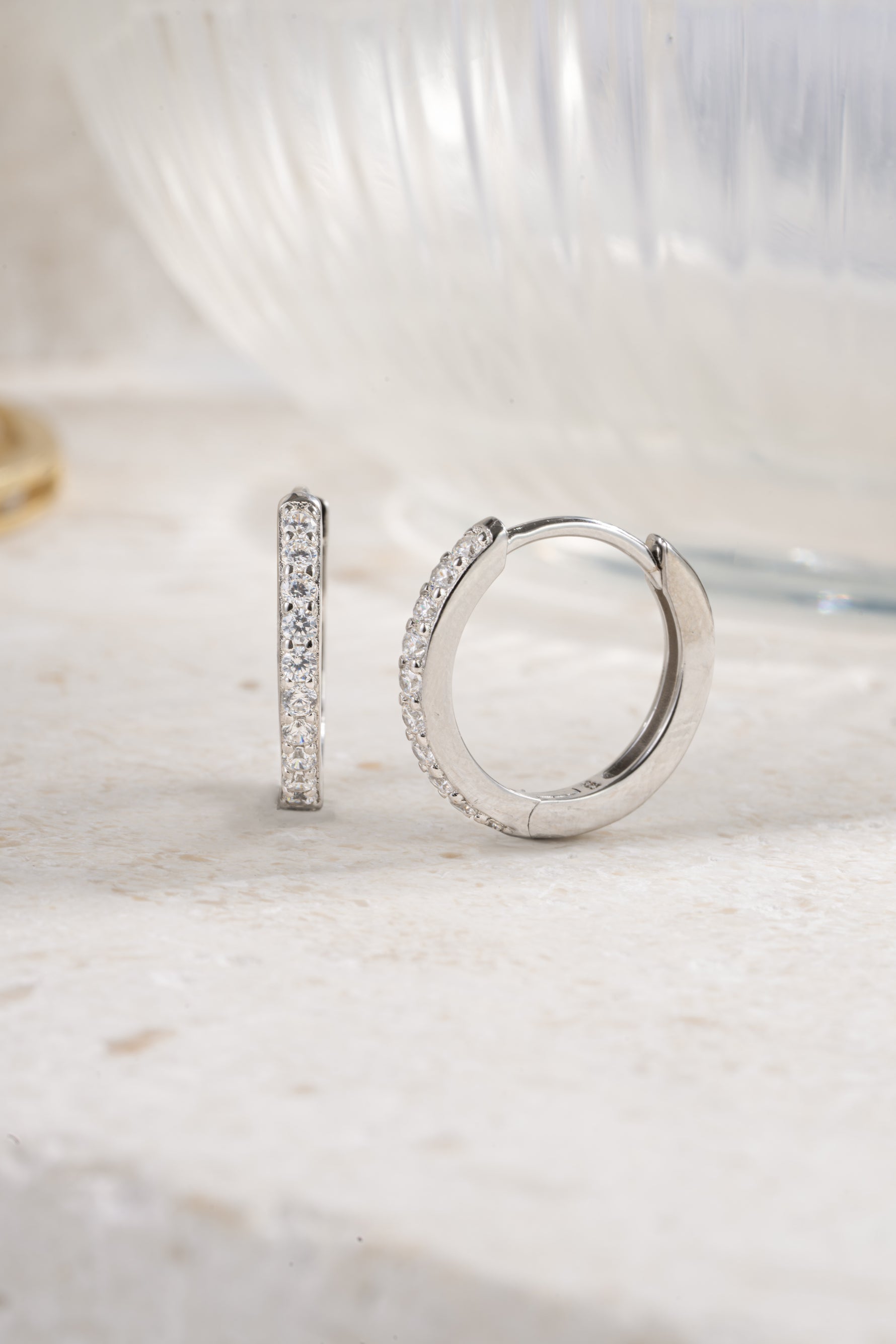 sterling silver 16mm studded huggie earrings neutral background