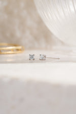 Sterling silver 2.5mm diamond solitaire stud earrings angled view white background