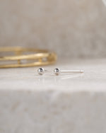 sterling silver 2mm ball stud earring on neutral background