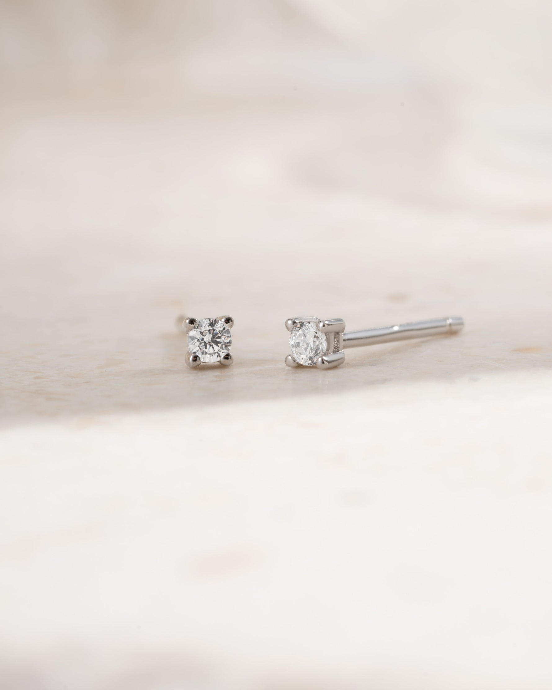 Sterling silver 2mm solitaire stud earrings  side view on white background