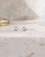 sterling silver 2.5mm diamond stud earring neutral background