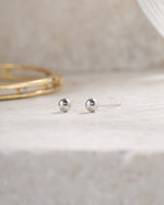 sterling silver 3mm ball stud earring on a simple background