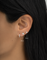 sterling silver 3mm solitaire stud earrings on womens ear with a 4mm size 