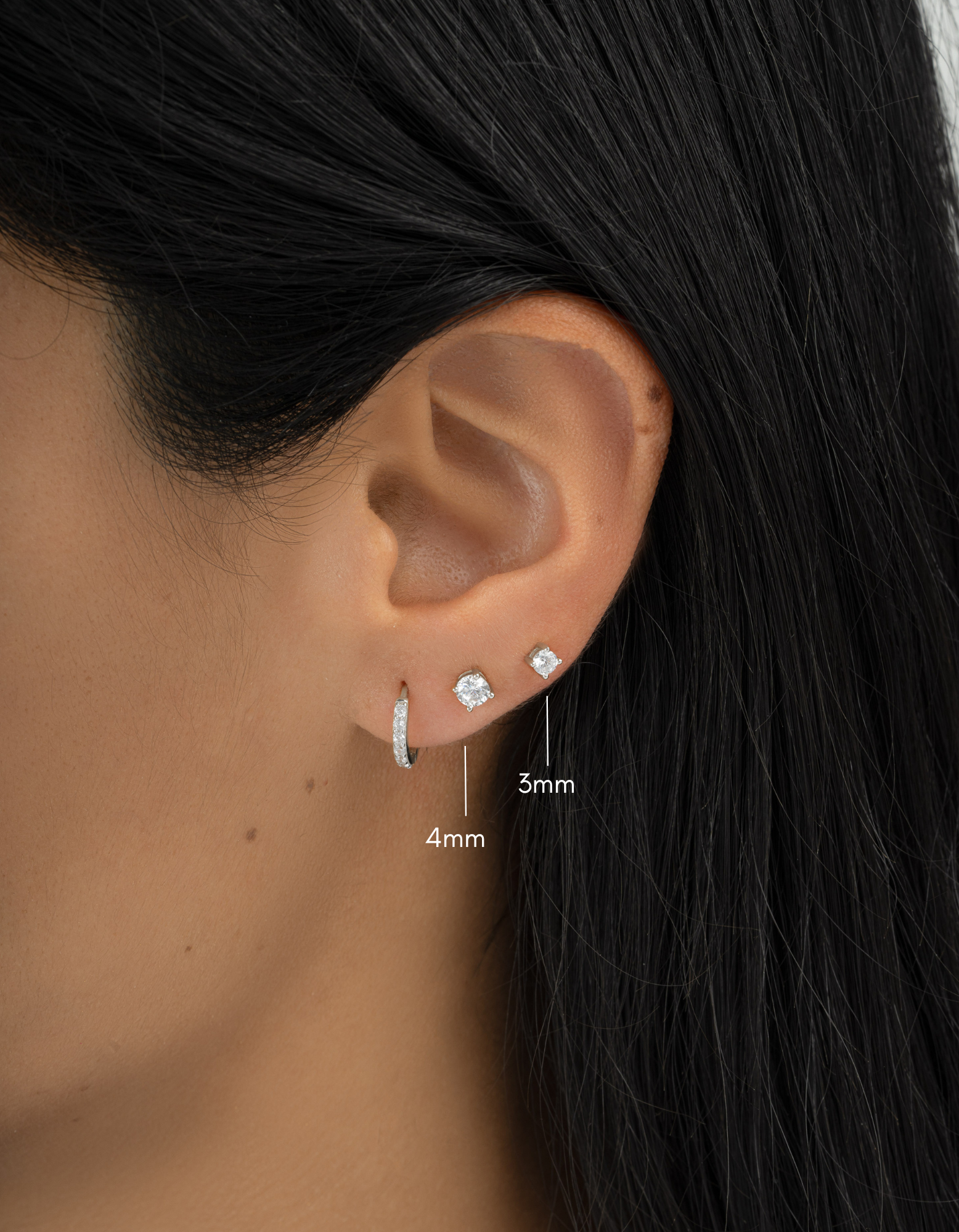 sterling silver 3mm solitaire stud earrings on womens ear with a 4mm size 